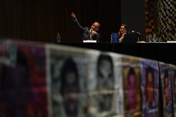 Carlos Beristain and Angela Buitrago attend a press conference by the Interdisciplinary Group of Independent Experts or GIEI, in Mexico City, Tuesday, July 25, 2023. The GIEI presented its sixth report on the case of the 43 students from Ayotzinapa who disappeared on Sept. 26, 2014. (AP Photo/Eduardo Verdugo)