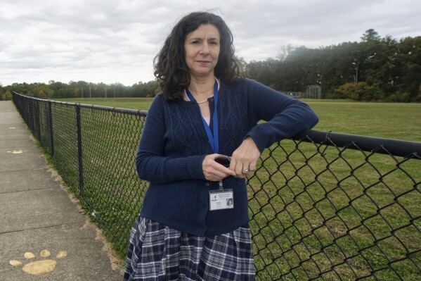 Heather Drane is photographed on Oct. 17, 2023, outside the Stafford County, Va., middle school where she now teaches after 18 years at a school in neighboring Spotsylvania County. Drane says she knows at least 10 other staff members who have left Spotsylvania schools in recent times, in part because of the "toxic stew" of school board meetings in the county. Over the past three years, local school board elections have become the place where America's deep political divisions are on full display. In Tuesday's elections in Virginia, far-right candidates are looking to take over a number of school boards or expand their slim majorities while the left fights fiercely to gain background. (AP Photo/Cal Woodward)