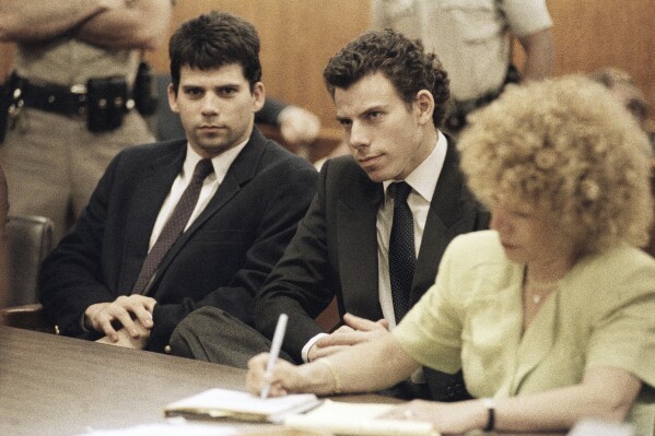 Lyle, left, and Erik Galen Menendez sit in Beverly Hills, Calif., courtroom, May 14, 1990 as a judge postponed their preliminary hearing on charges of murdering their parents last August. (AP Photo/Kevork Djansezian, File)