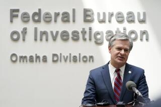 FILE - FBI Director Christopher Wray speaks during a news conference on Aug. 10, 2022, in Omaha, Neb. The White House is bringing together three dozen nations, the European Union and a slew of private-sector companies for a two-day summit starting Monday, Oct. 31, 2022, that looks at how best to combat ransomware attacks. Several administration officials are planning to participate in the event, including Wray. President Joe Biden was not expected to attend. (AP Photo/Charlie Neibergall, File)