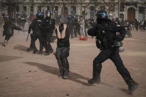 FILE - Police officers scuffle with protesters during a demonstration in Lyon, central France, on March 23, 2023. French authorities see the police as protectors ensuring that citizens can peacefully protest President Emmanuel Macron’s contentious retirement age increase. But to human rights advocates and demonstrators who were clubbed or tear-gassed, officers have overstepped their mission. (AP Photo/Laurent Cipriani, File)
