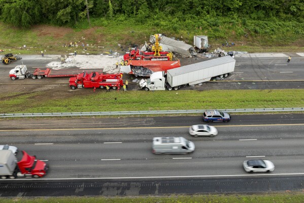 Emergency crews work to clear Interstate 75 southbound, where the Georgia State Patrol said that three people were killed, Tuesday, May 13, 2025 after a multiple-vehicle collision near Calhoun, Ga. (Tracey Trumbull/Local 3 News via AP)