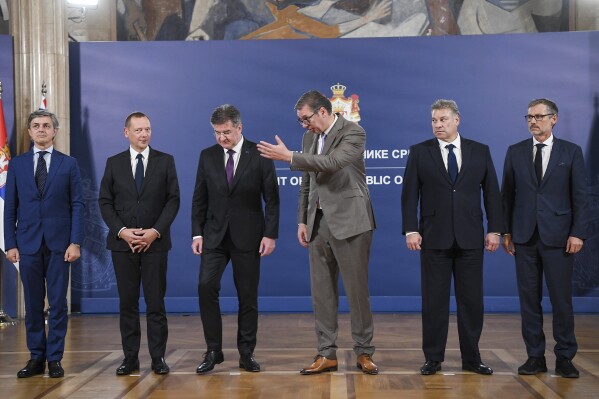 In this photo provided by the Serbian Presidential Press Service, Serbian President Aleksandar Vucic, third right, welcomes Italian diplomat Alessandro Cattaneo, left, French President's Advisor Emmanuel Bonne, second left, European Union envoy Miroslav Lajcak, third left, US Deputy Assistant Secretary Gabriel Escobar, second right, and German Chancellor's Advisor Jens Plettner, right, in Belgrade, Serbia, Saturday, Oct. 21, 2023. The envoys of the European Union and the United States urged on Saturday Kosovo and Serbia to resume dialogue as the only way to de-escalate the soaring tension between the two nations. This is the first such visit since Sept. 24 when around 30 Serb gunmen crossed into northern Kosovo, killing a police officer and setting up barricades, before launching an hours-long gun battle with Kosovo police. (Serbian Presidential Press Service via AP)