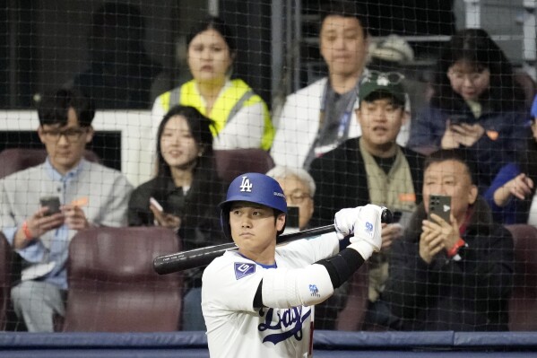 Los Angeles Dodgers' designated hitter Shohei Ohtani prepares to bat in the first inning of the exhibition game between the Los Angeles Dodgers and Kiwoom Heroes at the Gocheok Sky Dome in Seoul, South Korea, Sunday, March 17, 2024. The Los Angeles Dodgers and the San Diego Padres will meet in a two-game series on March 20th-21st in Seoul for the MLB World Tour Seoul Series. (AP Photo/)