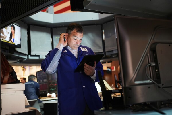 Christopher Lagana works on the floor at the New York Stock Exchange in New York, Wednesday, April 30, 2025. (AP Photo/Seth Wenig)