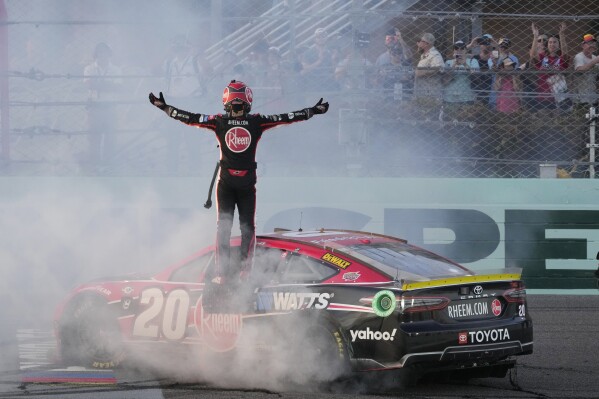 Christopher Bell (20) gets out of his car after winning the NASCAR Cup Series auto race at Homestead-Miami Speedway, Sunday, Oct. 22, 2023 in Homestead, Fla. (AP Photo/Marta Lavandier)