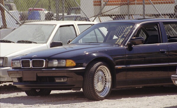 FILE - A black BMW, riddled with bullet holes, is seen in a Las Vegas police impound lot on Sept. 8, 1996. Rapper Tupac Shakur was shot while riding in the car driven by Death Row Records chairman Marion “Suge” Knight on Sept. 7, 1996, and died six days later. Knight was wounded but survived. (AP Photo/Lennox McLendon, File)