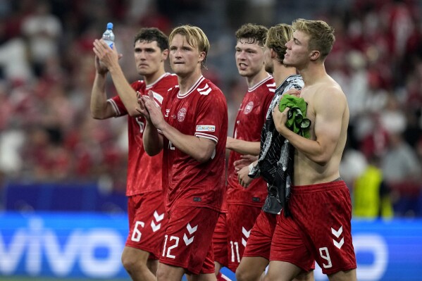  Denmark's Andreas Christensen (6), Kasper Dolberg (12) and teammates react after a Group C match between Denmark and Serbia at the Euro 2024 soccer tournament in Munich, Germany, Tuesday, June 25, 2024. (AP Photo/Antonio Calanni)