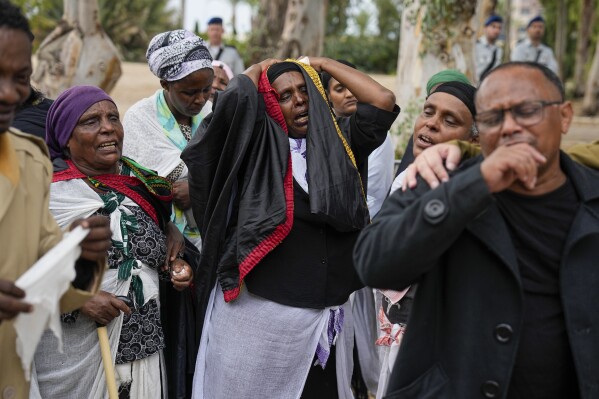 The family of Israeli soldier Cpl. Avraham Fetena mourn during his funeral in Haifa, Israel, Friday, Nov. 17, 2023. (AP Photo/Ariel Schalit)