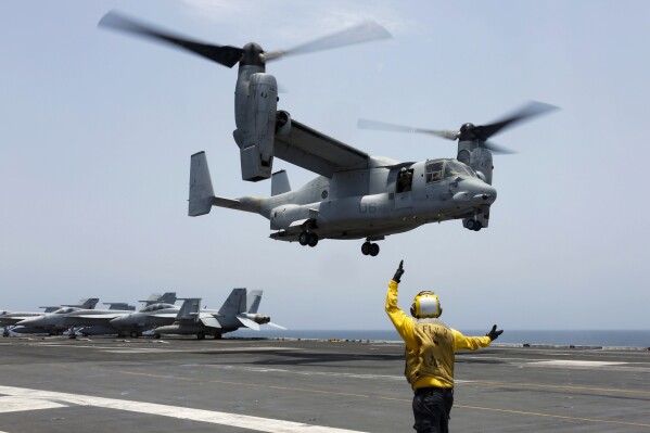 FILE -In this image provided by the U.S. Navy, Aviation Boatswain's Mate 2nd Class Nicholas Hawkins, signals an MV-22 Osprey to land on the flight deck of the USS Abraham Lincoln in the Arabian Sea on May 17, 2019. Air Force Special Operations Command said Tuesday it knows what failed on its CV-22B Osprey leading to a November crash in Japan that killed eight service members. But it still does not know why the failure happened. Because of the crash almost the entire Osprey fleet, hundreds of aircraft across the Air Force, Marine Corps and Navy, has been grounded since Dec. 6. (Mass Communication Specialist 3rd Class Amber Smalley/U.S. Navy via AP, File)