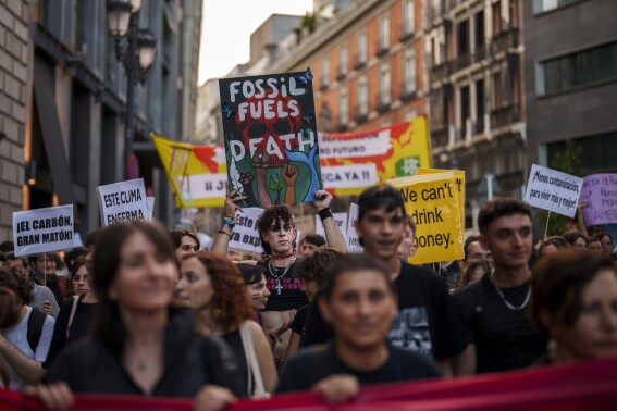 People take part in a Global Climate Strike 'Fridays For Future' protest in Madrid, Spain, Friday, Sept. 15, 2023. Tens of thousands of climate activists around the world are set to march, chant and protest Friday to call for an end to the burning of planet-warming fossil fuels as the globe suffers dramatic weather extremes and record-breaking heat. (AP Photo/Manu Fernandez)