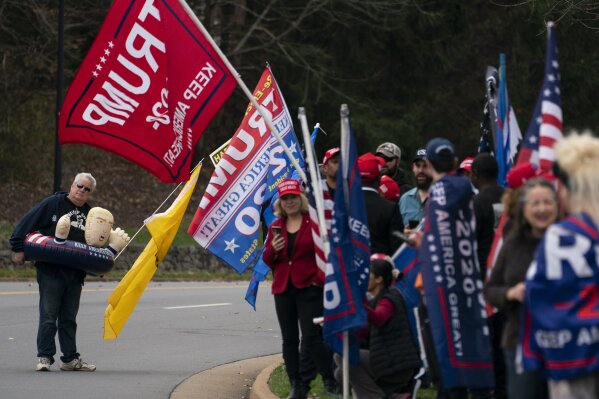 Supporters of President Donald Trump wait for him to depart Trump National Golf Club, Sunday, Nov. 15, 2020, in Sterling, Va. (AP Photo/Evan Vucci)