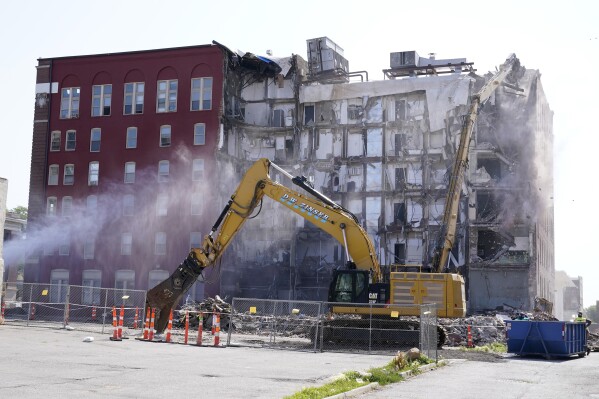 Workers begin demolition at the site of a building collapse, Monday, June 12, 2023, in Davenport, Iowa. The six-story, 80-unit building partially collapsed May 28. (AP Photo/Charlie Neibergall)