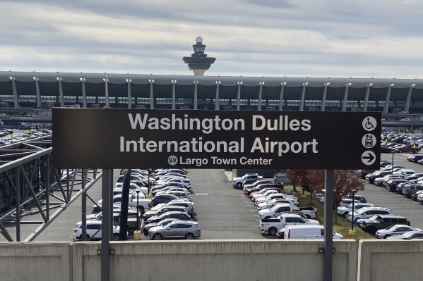 FILE - The Metrorail station at Dulles International Airport is seen on Nov. 2, 2022, in Chantilly, Va., with the terminal in the background. A man charged in 2019 with planning an Islamic State-inspired attack at a Washington, D.C., area shopping and entertainment complex has pleaded guilty in a separate plot to drive a stolen van into a crowd at the Virginia airport that was aborted. Rondell Henry of Germantown, Md., is to be sentenced Oct. 23, 2023, in federal court in connection with a 2019 plot at Dulles International Airport. (AP Photo/Matthew Barakat, File)