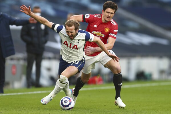FILE - In this Sunday, April 11, 2021 file photo Tottenham's Harry Kane, left, is challenged by Manchester United's Harry Maguire during the English Premier League soccer match between Tottenham Hotspur and Manchester United at the Tottenham Hotspur Stadium in London. UEFA President Aleksander Ceferin says players at the 12 clubs setting up their own Super League could be banned from this year's European Championship and next year's World Cup. (Clive Rose/Pool via AP)