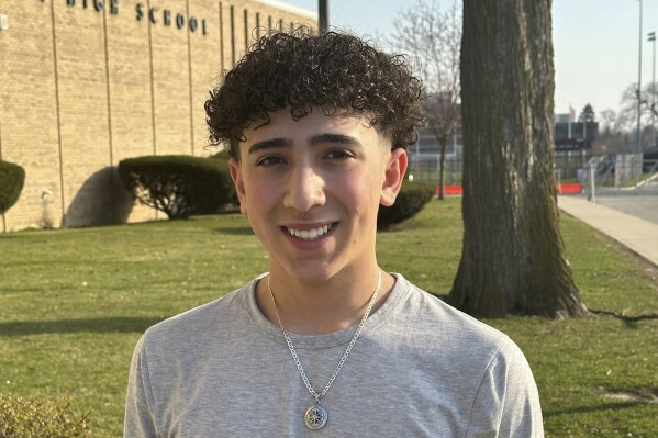 Adam Alcodray stands outside Dearborn High School on Wednesday, March 13, 2024 in Dearborn Mich. Alcodray, 14, is a 9th grader at the school which makes certain allowances for students observing Ramadan. Alcodray says Ramadan carries more significance this year given the plight of people in Gaza. “When you look at what the children are eating in Gaza, you appreciate what your mom makes,” he said. “When you’re having a bad day, realize what they are going through.”