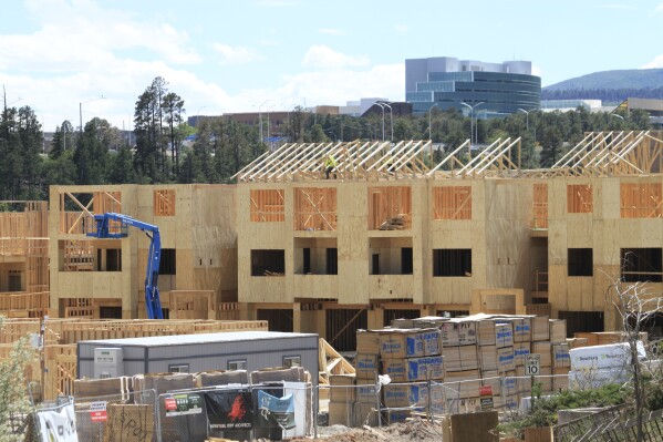 Construction work is underway at an apartment complex being built in Los Alamos, N.M., June 22, 2023. Los Alamos was the perfect spot for the U.S. government's top-secret Manhattan Project during World War II. Almost overnight, the remote location was transformed to accommodate thousands of people who were racing to develop the world's first atomic bomb. The community is facing growing pains again, 80 years later, as it works to modernize the country's nuclear arsenal. (AP Photo/Susan Montoya Bryan)