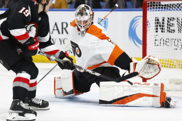Philadelphia Flyers goaltender Samuel Ersson, right, makes a save against Buffalo Sabres center Peyton Krebs (19) during the first period of an NHL hockey game, Monday, Jan. 9, 2023, in Buffalo, N.Y. (AP Photo/Jeffrey T. Barnes)