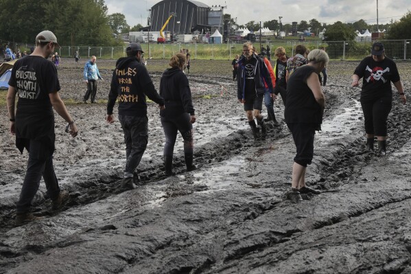 A fan walks in the stands as rain canceled the start of the