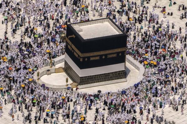 FILE - Muslim pilgrims walk around the Kaaba, the cubic building at the Grand Mosque, during the annual hajj pilgrimage, in Mecca, Saudi Arabia, on July 10, 2022. Police in Mecca say they have arrested a Saudi man who helped an Israeli-Jewish reporter sneak into the city, defying a rule that only Muslims can enter the area that is home to Islam's holiest site. (AP Photo/Amr Nabil, File)