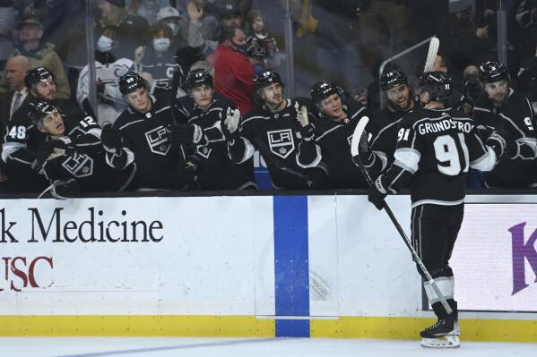 Los Angeles Kings left wing Carl Grundstrom, right, is congratulated at the bench after scoring a goal in the second period of an NHL hockey game against the Buffalo Sabres, Sunday, Oct. 31, 2021, in Los Angeles. (AP Photo/Jayne Kamin-Oncea)