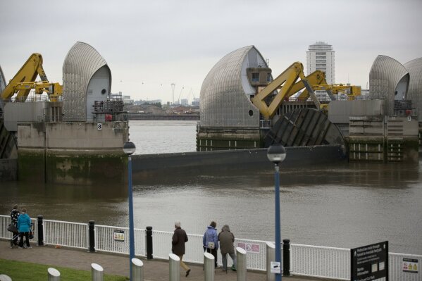
              FILE - This Thursday, May 8, 2014 file photo shows a sector gate on the Thames Barrier reopening for one of its monthly tests on the River Thames in east London. It is designed to block exceptionally high tides or storm surges from the North Sea. (AP Photo/Matt Dunham, File)
            