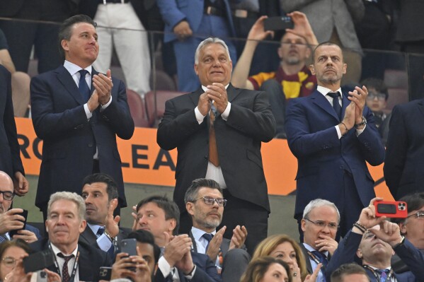 FILE - Hungarian Prime Minster Viktor Orban, center, and UEFA president Aleksander Ceferin, right, stand before the Europa League final soccer match between Sevilla and Roma, at the Puskas Arena in Budapest, Hungary, Wednesday, May 31, 2023. This month in Budapest, the spotlight will shine on Hungary, a country led by Orban a prime minister with authoritarian leanings and a shaky human-rights record. Budapest's latest step onto the international stage starts Saturday, the opening of the nine-day track and field world championships. (AP Photo/Denes Erdos, File)