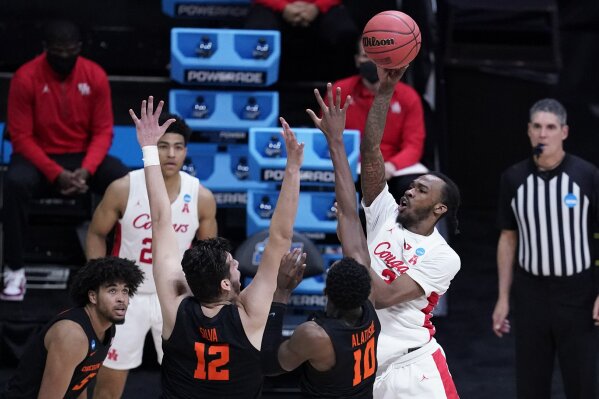 Houston guard DeJon Jarreau (3) shoots over Oregon State forward Warith Alatishe (10) during the second half of an Elite 8 game in the NCAA men's college basketball tournament at Lucas Oil Stadium, Monday, March 29, 2021, in Indianapolis. (AP Photo/Darron Cummings)