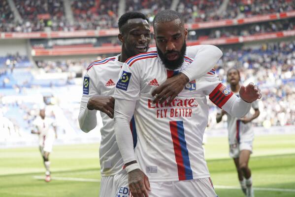 Lyon's Alexandre Lacazette, front, celebrates scoring his side's 2nd goal during the French League One soccer match between Lyon and Rennes at the Groupama stadium, in Decines, near Lyon, France, Sunday, April 9, 2023. (AP Photo/Laurent Cipriani)