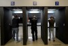 FILE - Gun owners fire their pistols at an indoor shooting range during a qualification course to renew their carry concealed handgun permits, July 1, 2022, at the Placer Sporting Club in Roseville, Calif. A California law that bans people from carrying firearms in most public places is taking effect on New Year's Day, even as a court case continues to challenge the law. (AP Photo/Rich Pedroncelli, File)