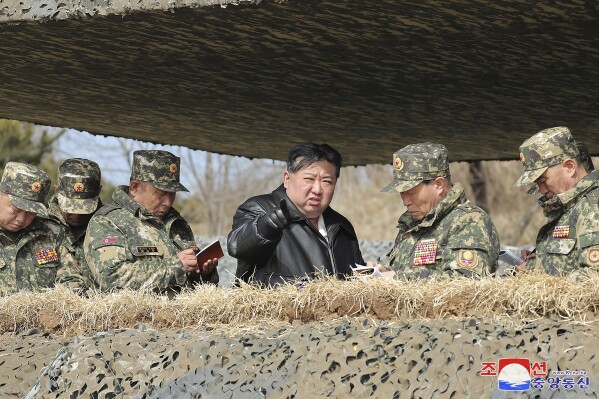 In this photo provided by the North Korean government, North Korean leader Kim Jong Un, center, supervises artillery firing drills in North Korea Thursday, March 7, 2024. Independent journalists were not given access to cover the event depicted in this image distributed by the North Korean government. The content of this image is as provided and cannot be independently verified. Korean language watermark on image as provided by source reads: 