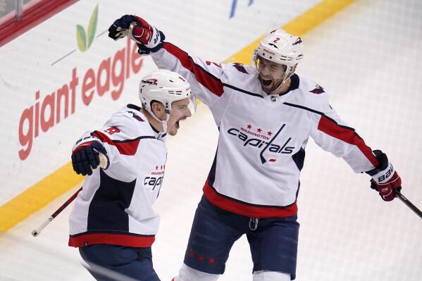 Washington Capitals' Dmitry Orlov (9) celebrates his goal with Justin Schultz during the first period of an NHL hockey game against the Pittsburgh Penguins in Pittsburgh, Tuesday, Feb. 1, 2022. (AP Photo/Gene J. Puskar)