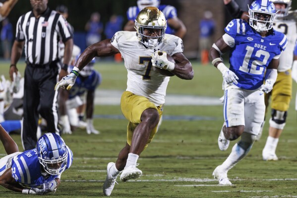 FILE - Notre Dame's Audric Estimé (7) carries the ball during an NCAA college football game in Durham, N.C., Saturday, Sept. 30, 2023. Estimé has been selected to The Associated Press midseason All-America team, Wednesday, Oct. 18, 2023. (AP Photo/Ben McKeown, File)