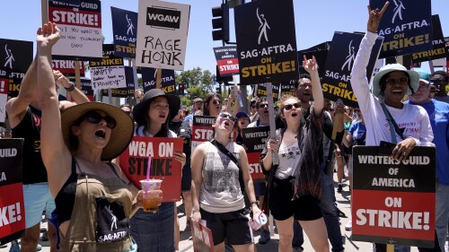 Striking writers and actors take part in a rally outside Paramount studios in Los Angeles on Friday, July 14, 2023. This marks the first day actors formally joined the picket lines, more than two months after screenwriters began striking in their bid to get better pay and working conditions. (AP Photo/Chris Pizzello)