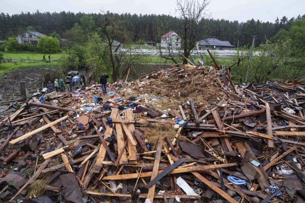 A man stands on the rubble of a destroyed house where three children were killed by a Russian strike in Korostyshiv, Zhytomyr region, Ukraine, Sunday, May 25, 2025. (AP Photo/Evgeniy Maloletka)