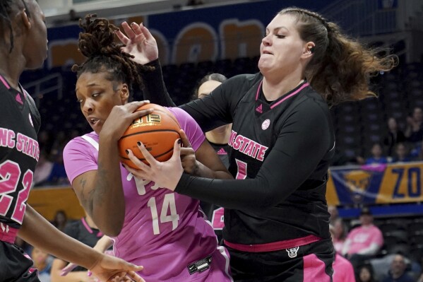 Pittsburgh forward Jala Jordan (14) fights for a rebound against North Carolina State center River Baldwin (1) during the first half of an NCAA college basketball game Sunday, Feb. 11, 2024, in Pittsburgh. (AP Photo/Matt Freed)