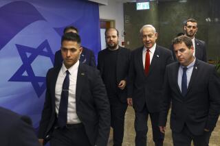 Israeli Prime Minister Benjamin Netanyahu, center right, arrives at a cabinet meeting at the prime minister's office in Jerusalem Sunday, April 2, 2023. (Ronen Zvulun/Pool Photo via AP)