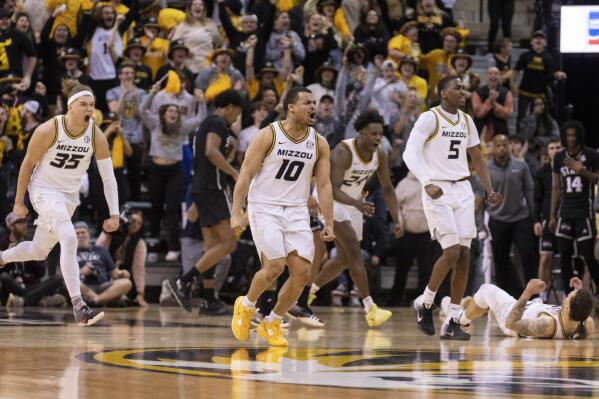 Missouri's Noah Carter, Nick Honor, Kobe Brown (24), D'Moi Hodge and Tre Gomillion, from left, celebrate after the team's overtime win against Mississippi State in an NCAA college basketball game Tuesday, Feb. 21, 2023, in Columbia, Mo. (AP Photo/L.G. Patterson)
