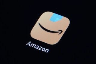 FILE - The Amazon app is seen on a smartphone, Tuesday, Feb. 28, 2023, in Marple Township, Pa. After months of complaints from the Authors Guild and other groups, Amazon.com started requiring writers who want to sell books through its e-book program to tell the company in advance that their work includes artificial intelligence material. (AP Photo/Matt Slocum, File)