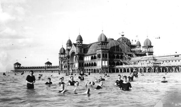 People swim at Saltair in 1933, in the Great Salt Lake, in Utah. Saltair, a resort long since closed, once drew sunbathers who would float like corks in the extra salty waters. Picnic tables once a quick stroll from the shore are now a 10-minute walk away. (Salt Lake Tribune via AP)