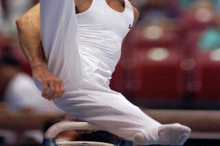 FILE - In this June 6, 1991, file photo, Kurt Thomas, 35, competes on the pommel horse at the U.S. Gymnastics Championships in the compulsory round in Cincinnati. Thomas, the first U.S. male gymnast to win a world championship gold medal, has died. He was 64. Thomas’ family said he died Friday, June 5, 2020. He had a stroke May 24, caused by a tear of the basilar artery in the brain stem. (AP Photo/Michael Snyder, File)