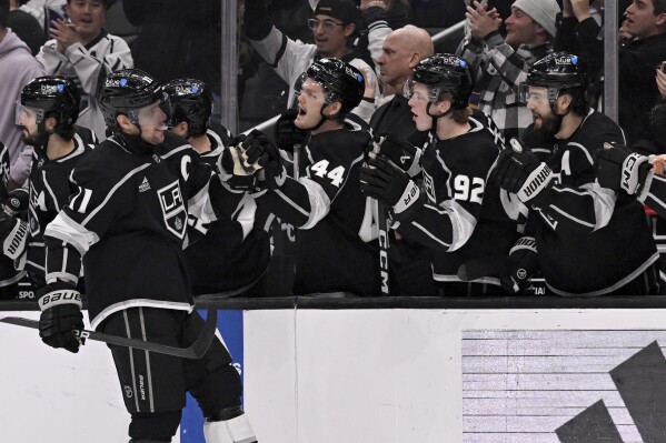 Los Angeles Kings center Anze Kopitar (11) is congratulated for his goal against the Buffalo Sabres during the first period of an NHL hockey game in Los Angeles, Wednesday, Jan. 24, 2024. (AP Photo/Alex Gallardo)
