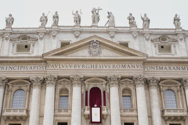 Pope Leo XIV appears at the central balcony of St. Peter's Basilica for his first Sunday blessing after his election, in St. Peter's Square at the Vatican, Sunday, May 11, 2025.(AP Photo/Gregorio Borgia)