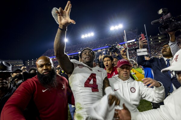 Alabama quarterback Jalen Milroe (4) celebrates after an NCAA college football game against Auburn, Saturday, Nov. 25, 2023, in Auburn, Ala. (AP Photo/Vasha Hunt)