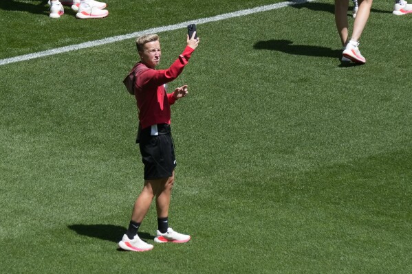 Coach Beverly Priestman of Canada takes photos on the pitch at Geoffroy-Guichard Stadium ahead of the 2024 Summer Olympics, Tuesday, July 23, 2024, in Saint-Etienne, France. Canada is scheduled to play New Zealand on Thursday, July 25. (ĢӰԺ Photo/Silvia Izquierdo)