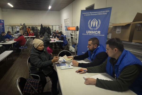 Employees of the UN Refugee Agency register refugees from the Donetsk region, the site of heavy battles with the Russian troops, in Pavlohrad, Dnipropetrovsk region, Ukraine, Thursday, Dec. 12, 2024. (AP Photo/Efrem Lukatsky)