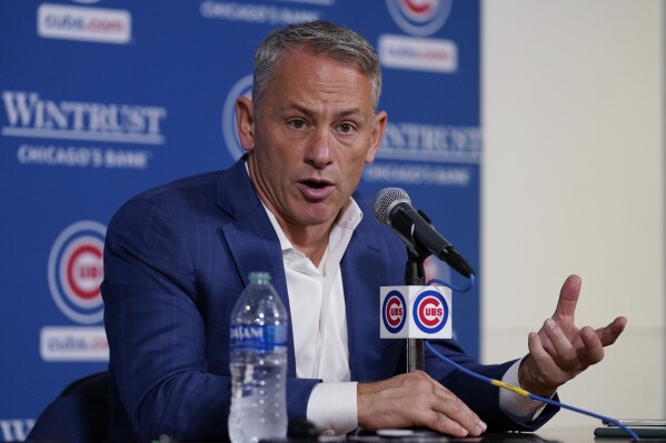 President Jed Hoyer of the Chicago Cubs presents a jersey to