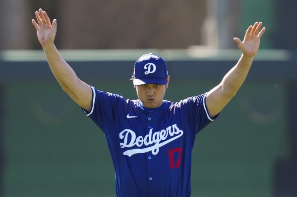 FILE - Los Angeles Dodgers designated hitter Shohei Ohtani participates in spring training baseball workouts at Camelback Ranch in Phoenix, Wednesday, Feb. 14, 2024. (AP Photo/Ashley Landis)