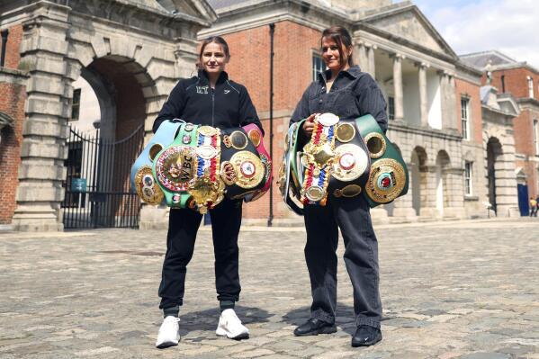 Katie Taylor the undisputed lightweight champion, left, and Chantelle Cameron, right, undisputed super-lightweight champion during a photo call at Dublin castle, Ireland, Thursday, May 18, 2023, ahead of their Undisputed Super Light-weight Championship in Dublin on Saturday. (AP Photo/Peter Morrison)