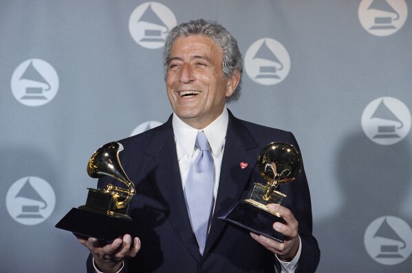 FILE - Veteran singer Tony Bennett displays his two Grammy's backstage at the Shrine Auditorium in Los Angeles Wednesday, March 1, 1995. Bennett, the eminent and timeless stylist whose devotion to classic American songs and knack for creating new standards such as "I Left My Heart In San Francisco" graced a decadeslong career that brought him admirers from Frank Sinatra to Lady Gaga, died Friday, July 21, 2023. He was 96. (AP Photo/Mark J. Terrill, File)